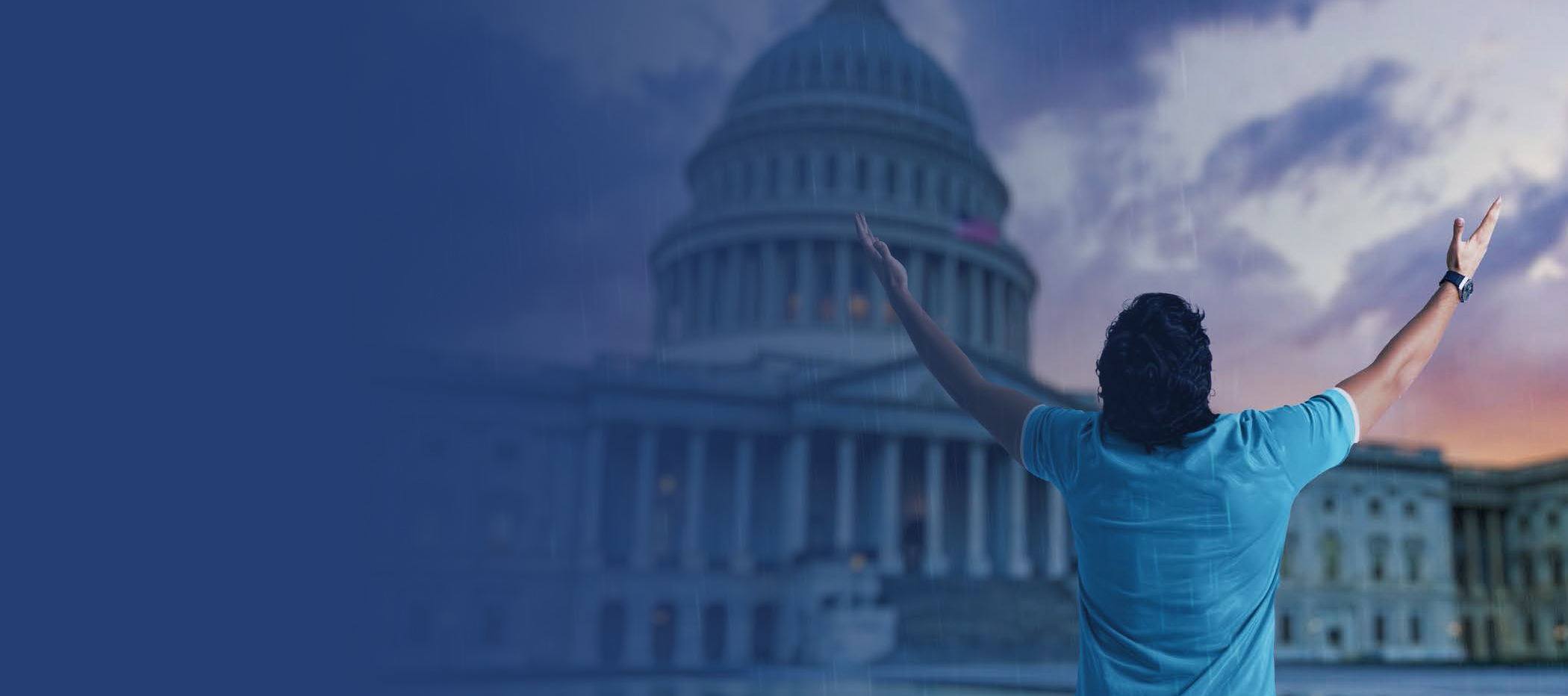 Person with arms raised toward the Capitol building under a dramatic sky